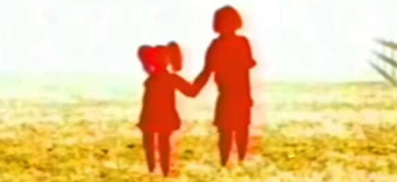 Molly Walten holding Edd Walten's hand as they walk through Wonderland